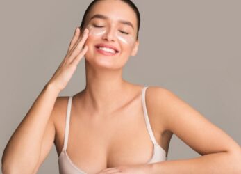 Woman touching her cheek with smooth, rejuvenated skin