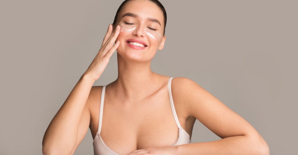 Woman touching her cheek with smooth, rejuvenated skin