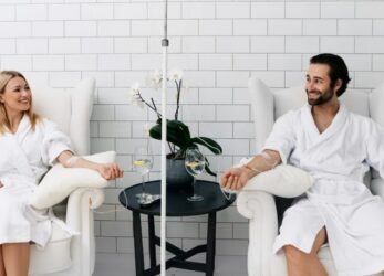 Man and woman in spa robes relaxing side by side during an IV therapy session